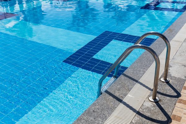 Pool Steps with Blue Tiles and Stainless-Steel Handrail